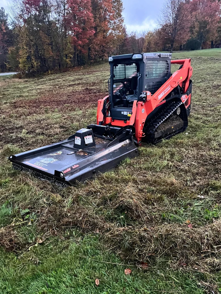 machine clearing ground in a field