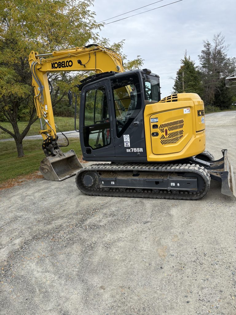 start of portfolio kobelco excavator parked on dirt road